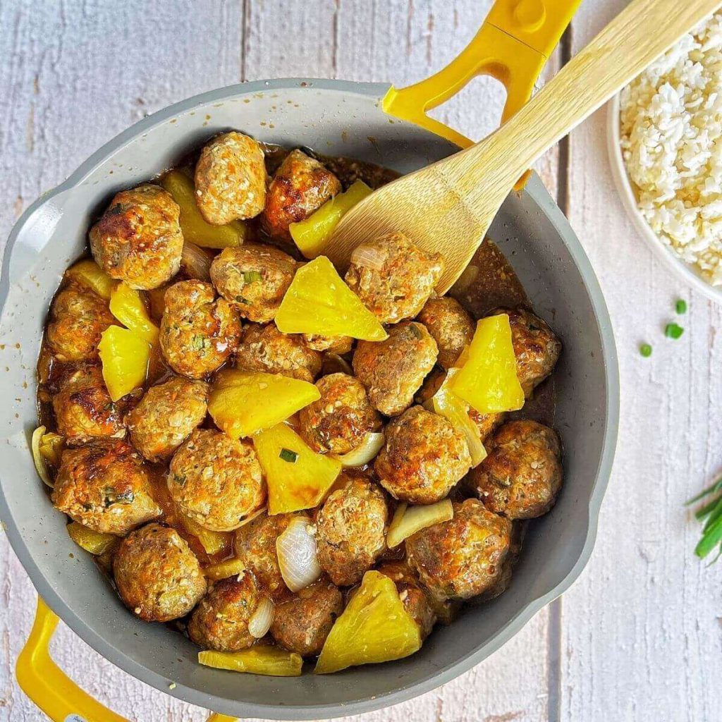 Sweet and sour meatballs with pineapple in a pan