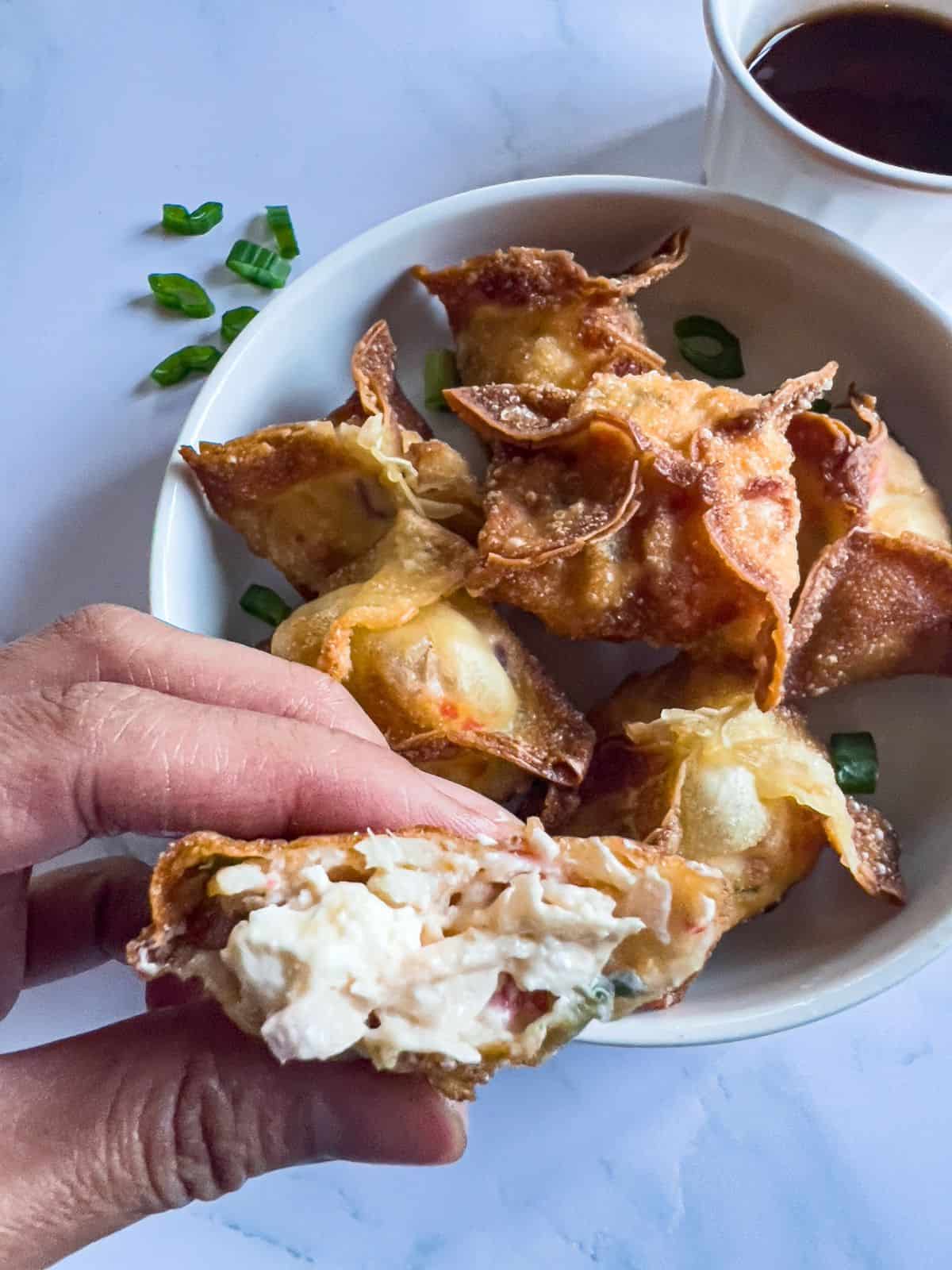 Finish dish of crispy crab rangoon with a bite.