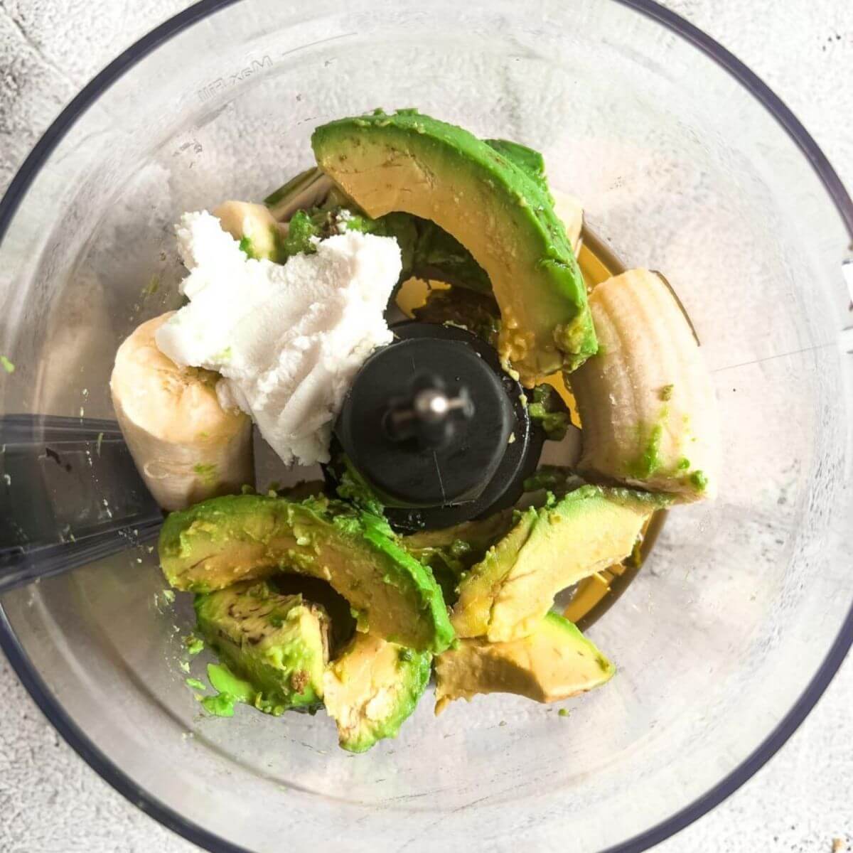 Ingredients for avocado nice cream together in food processor