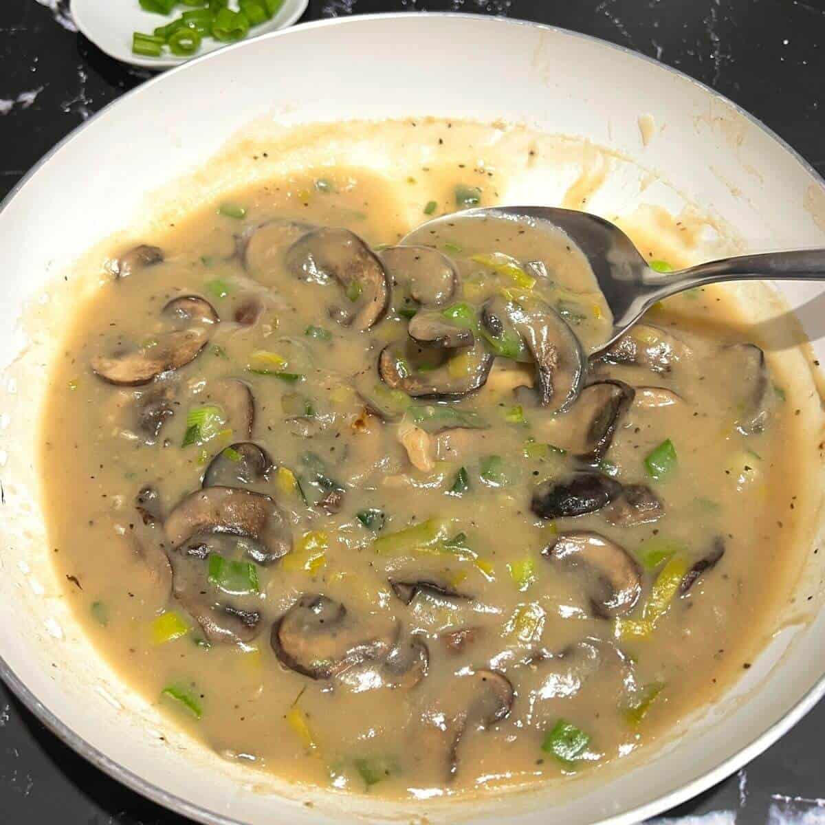 Mushroom gravy in skillet.