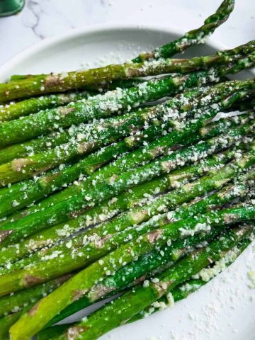 Finish dish of Air-fryer Roasted Asparagus with parmesan cheese.