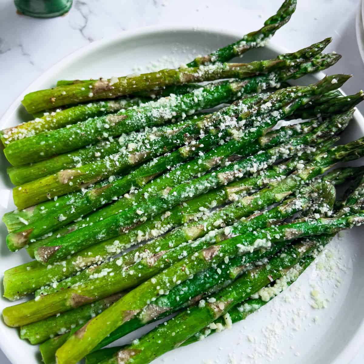Finish dish of Air-fryer Roasted Asparagus with parmesan cheese.
