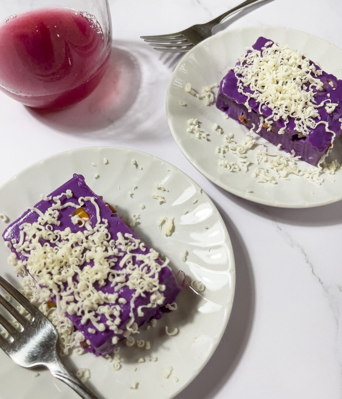 Ube maja blanca in two plates with drink.