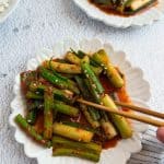 Green onion kimchi in a small serving plate.