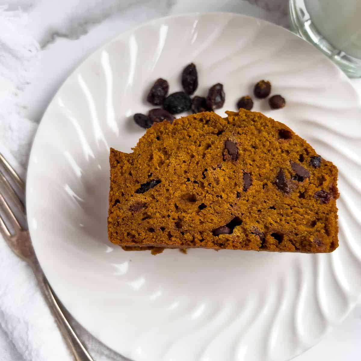 A sliced of pumpkin bread with chocolate chips and raisins.. 