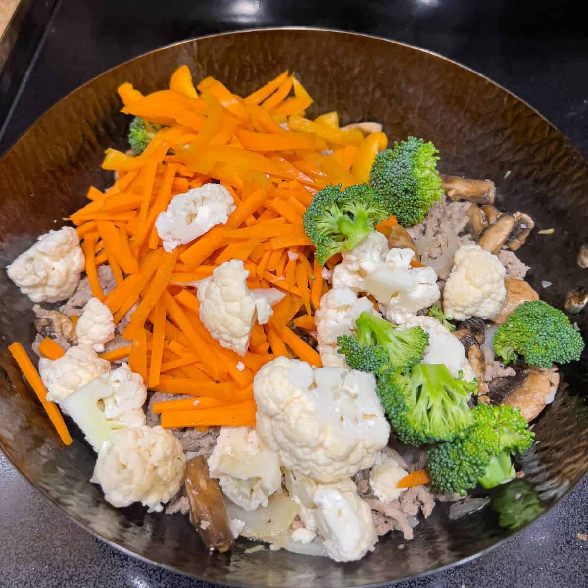 Stir fry carrots, broccoli and cauliflower.