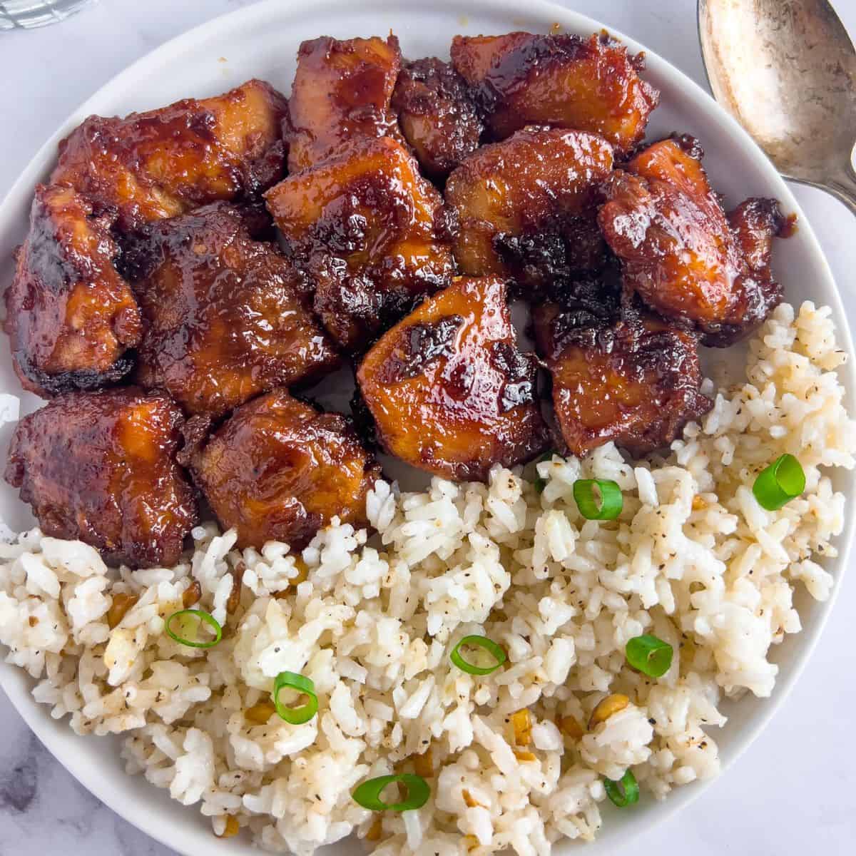 Chicken tocino in a plate with garli fried rice.