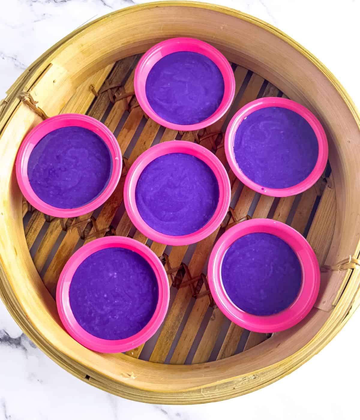 Ube puto mixture in a bamboo steamer.