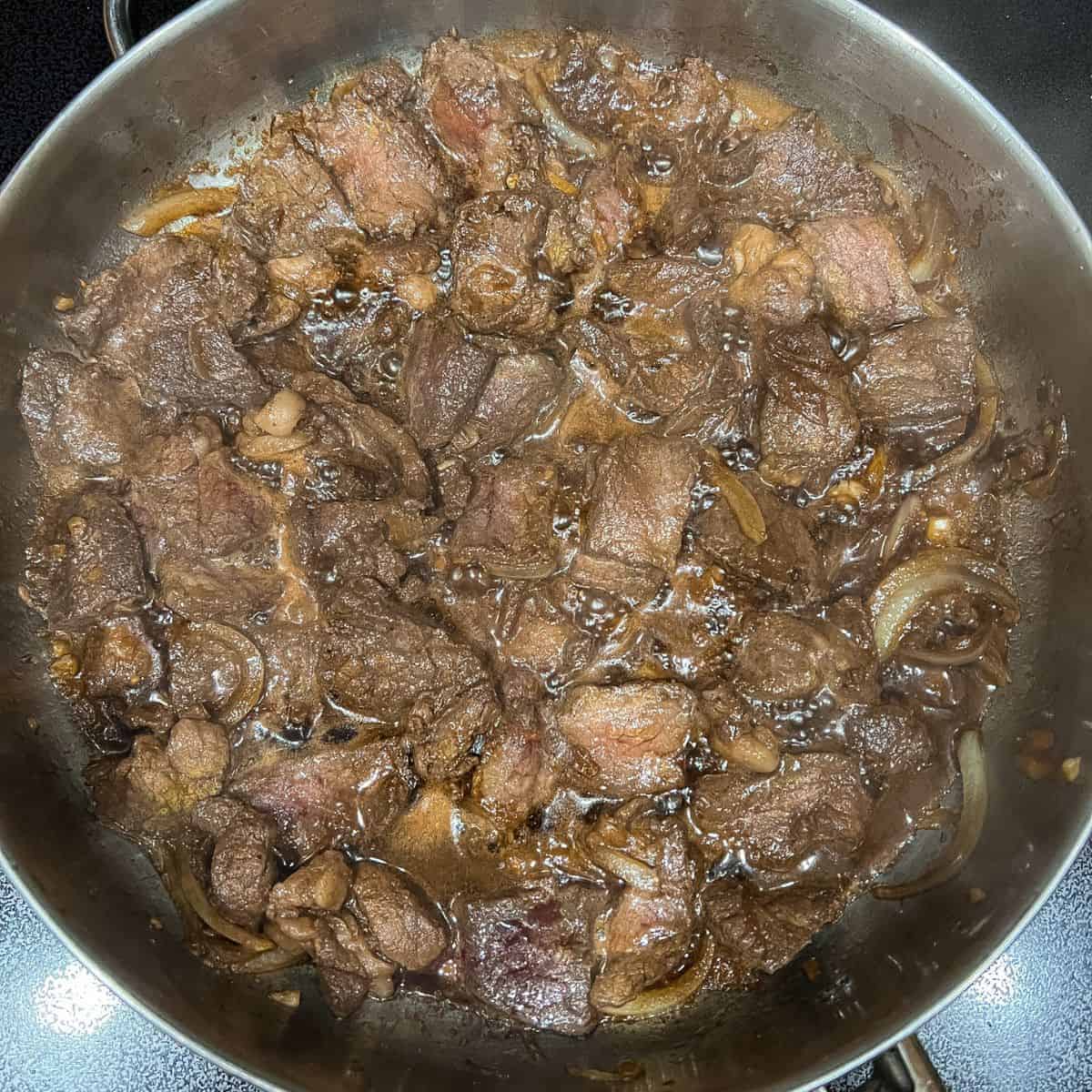 Sautee onion and garlic then add beef and cook.