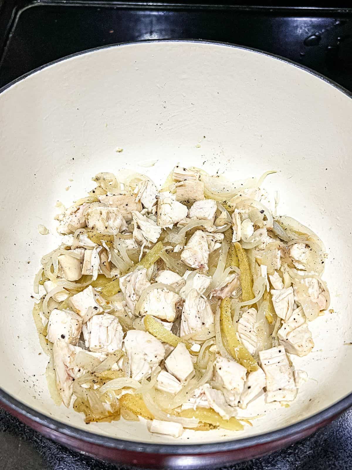 Sauted onion, garlic, ginger, and chicken in a dutch oven.