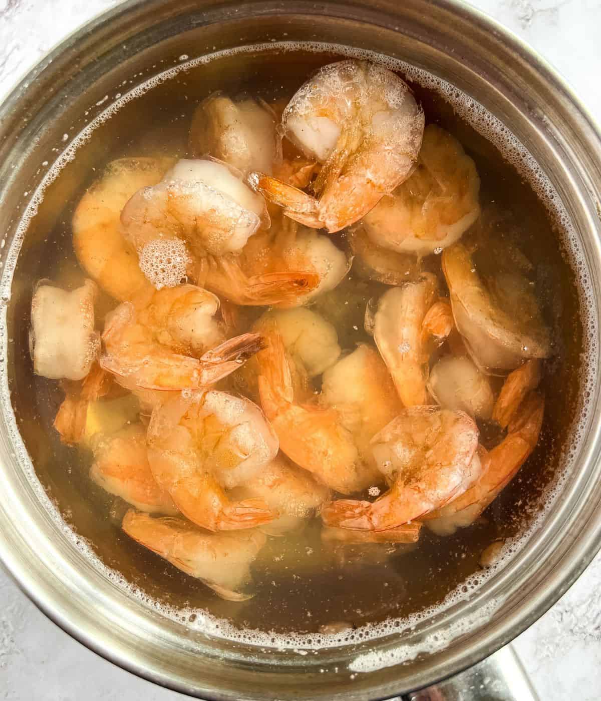 Cooking shrimp and saving the water for cooking.