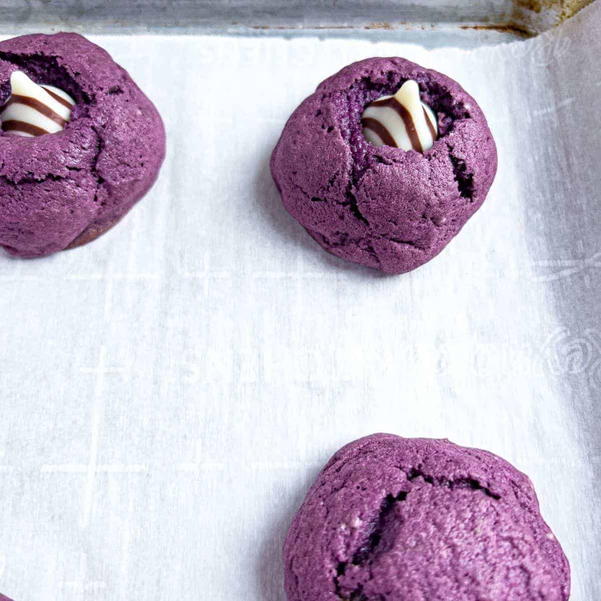 Finish baked ube cookies with milk chocolate on top.