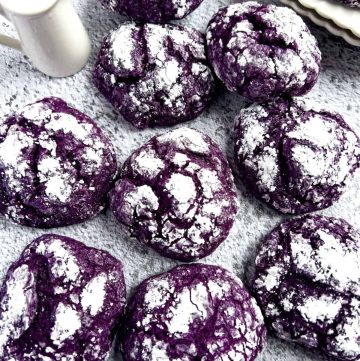 Ube crinkle cookies on the table with milk.