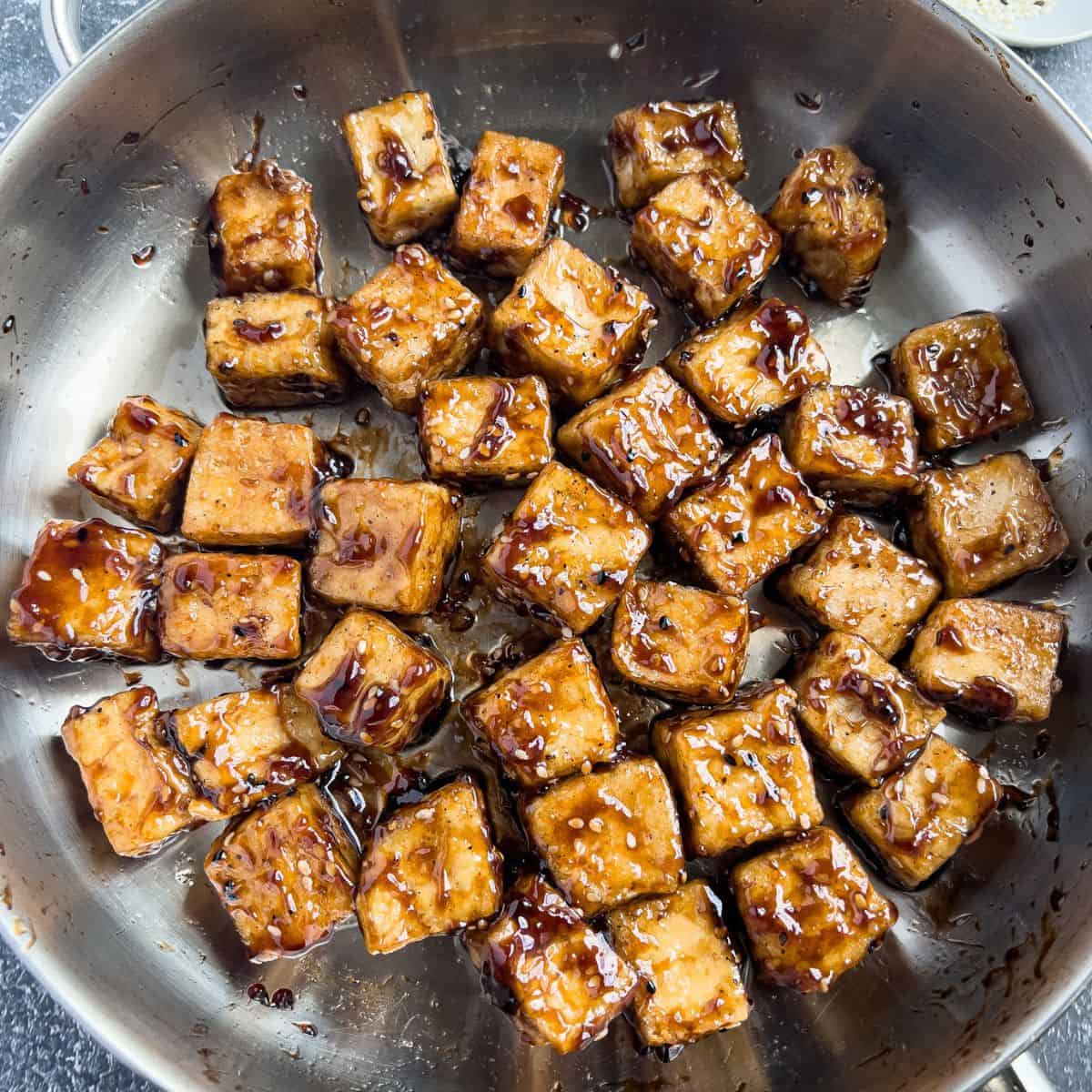 Finish dish of sweet and sticky tofu in a skillet.