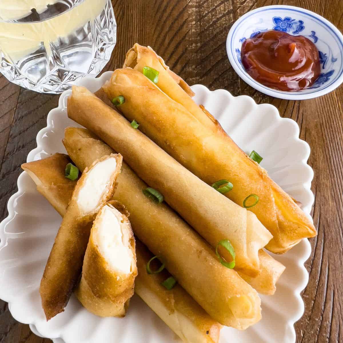 Finish dish of cheese lumpia on the table with dipping.