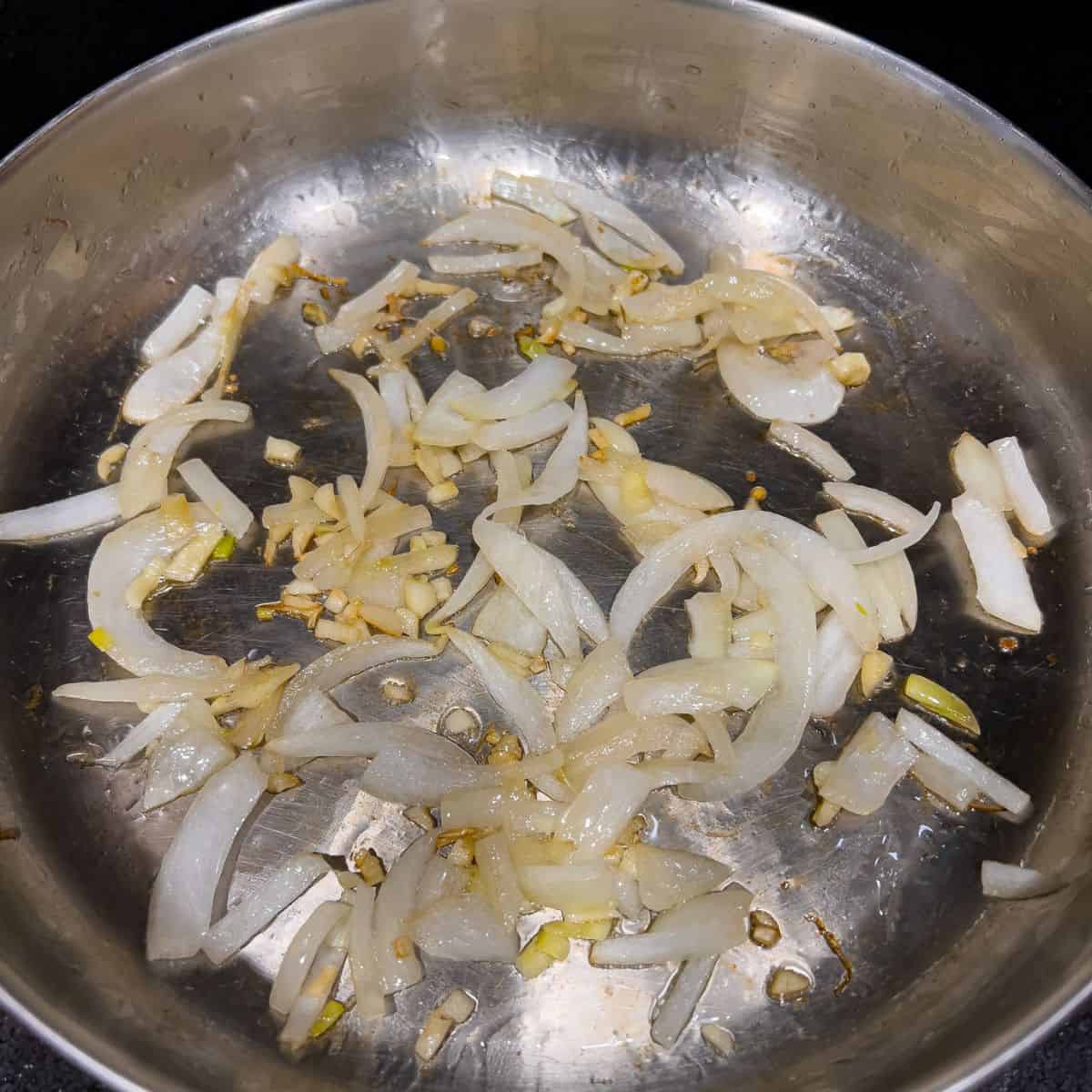 Cooking garlic and onion in a skillet.