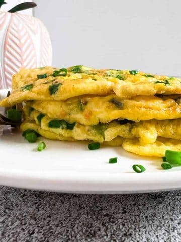Finish dish of keto green onion pancake with egg in a plate.