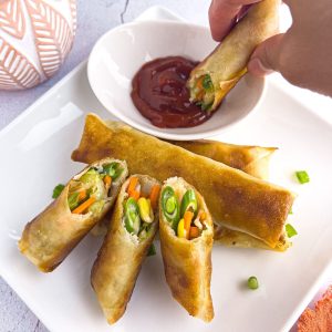Finish dish of crispy vegetable lumpia with a dipping sauce.