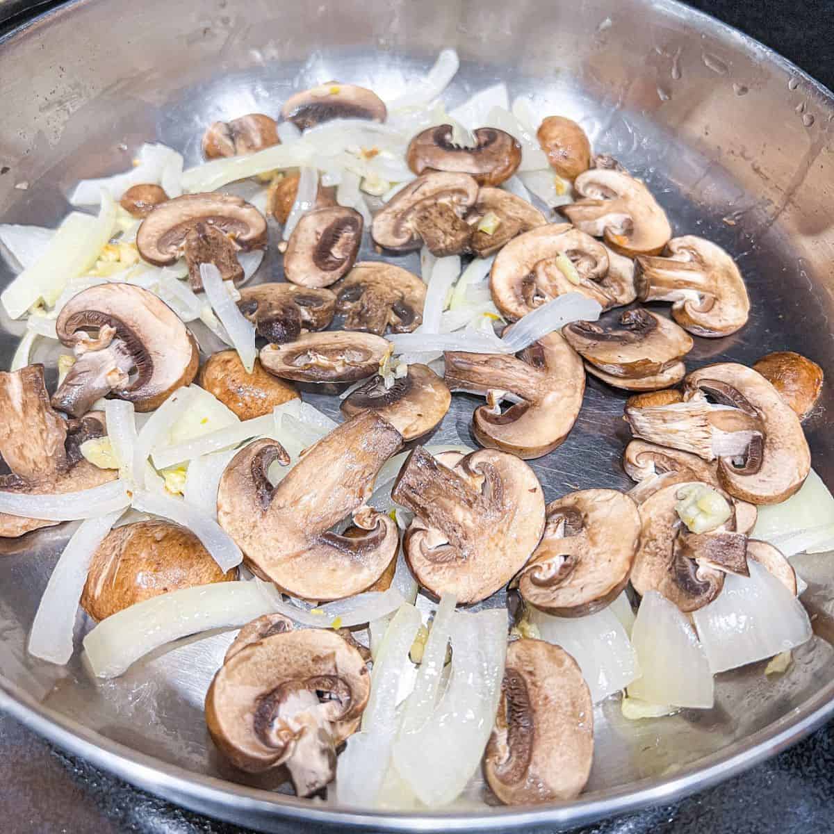 Cooking onion, garlic and mushrooms.