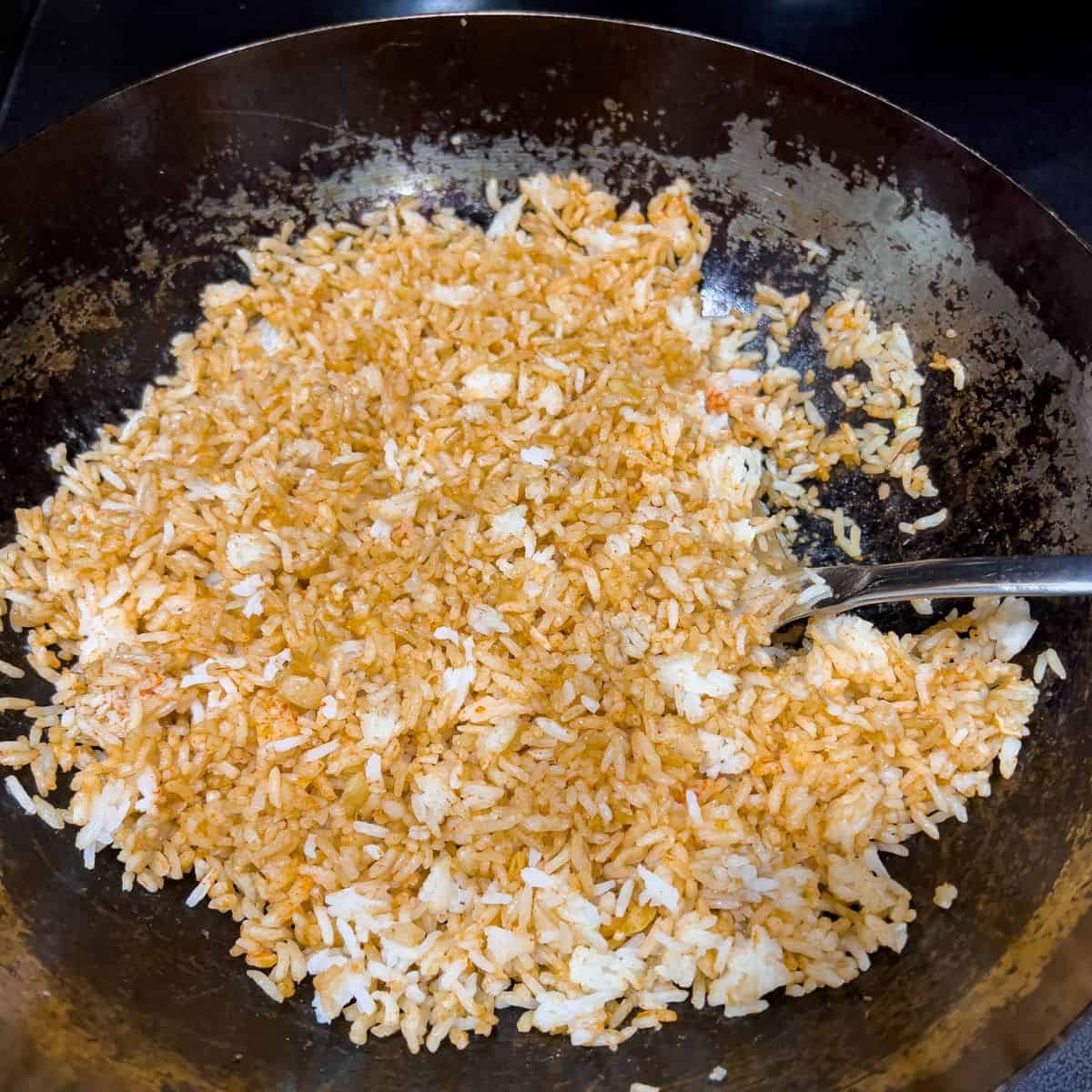 Cooking fried rice in a wok.