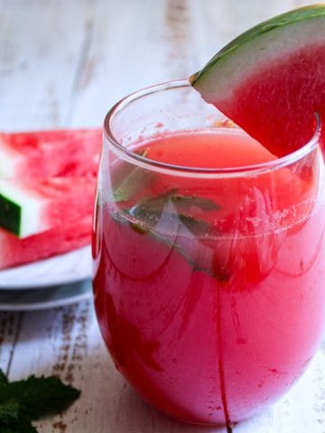 Watermelon refresher in a glass, ready to serve with watermelon slices.