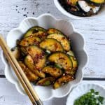 Finish side dish of spicy cucumber banchan in a bowl.