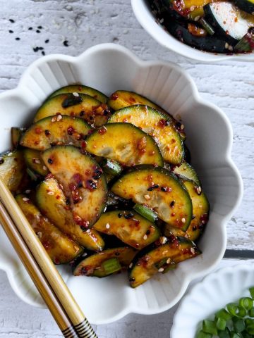 Finish side dish of spicy cucumber banchan in a bowl.