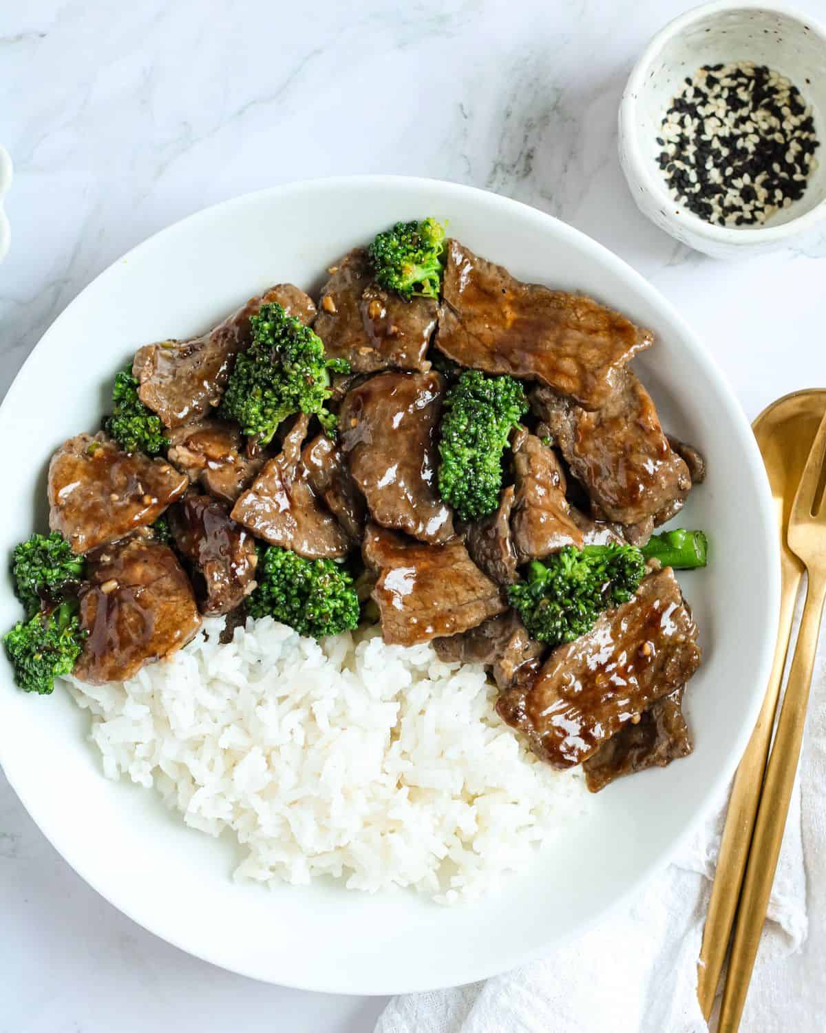 A bowl with beef and broccoli dish with rice.