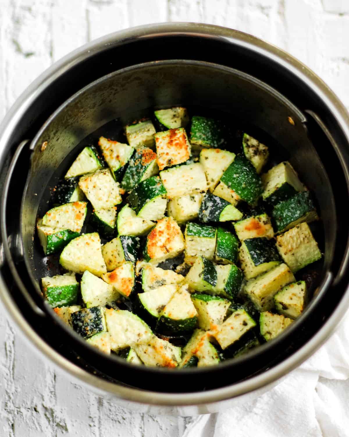 Finish dish of roasted zucchini in the air-fryer basket.