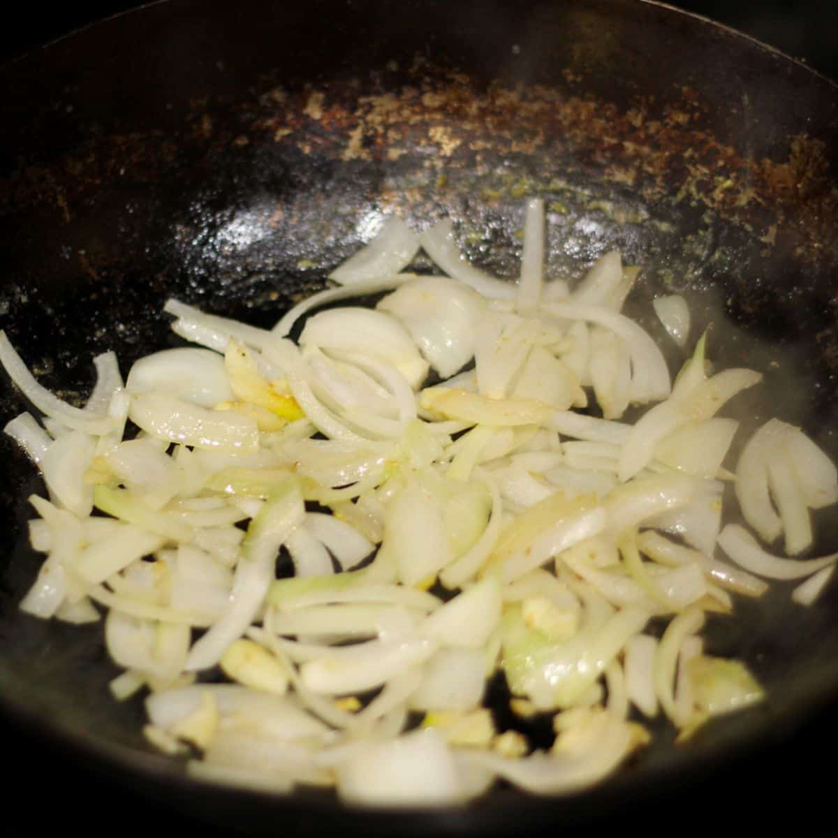 Cooking onion and garlic in a wok.