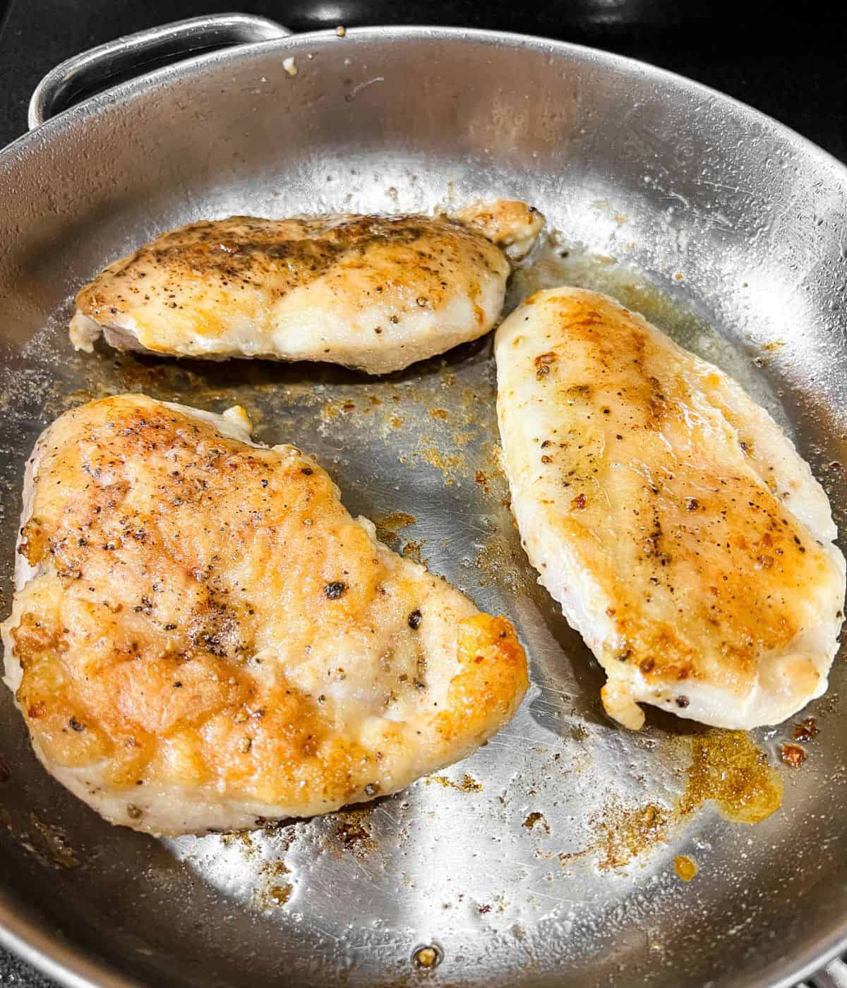 Frying chicken in a skillet.