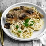 Finish dish of chicken marsala in a plate with pasta.