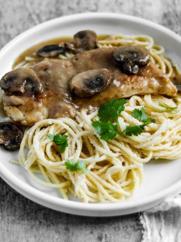 Finish dish of chicken marsala in a plate with pasta.