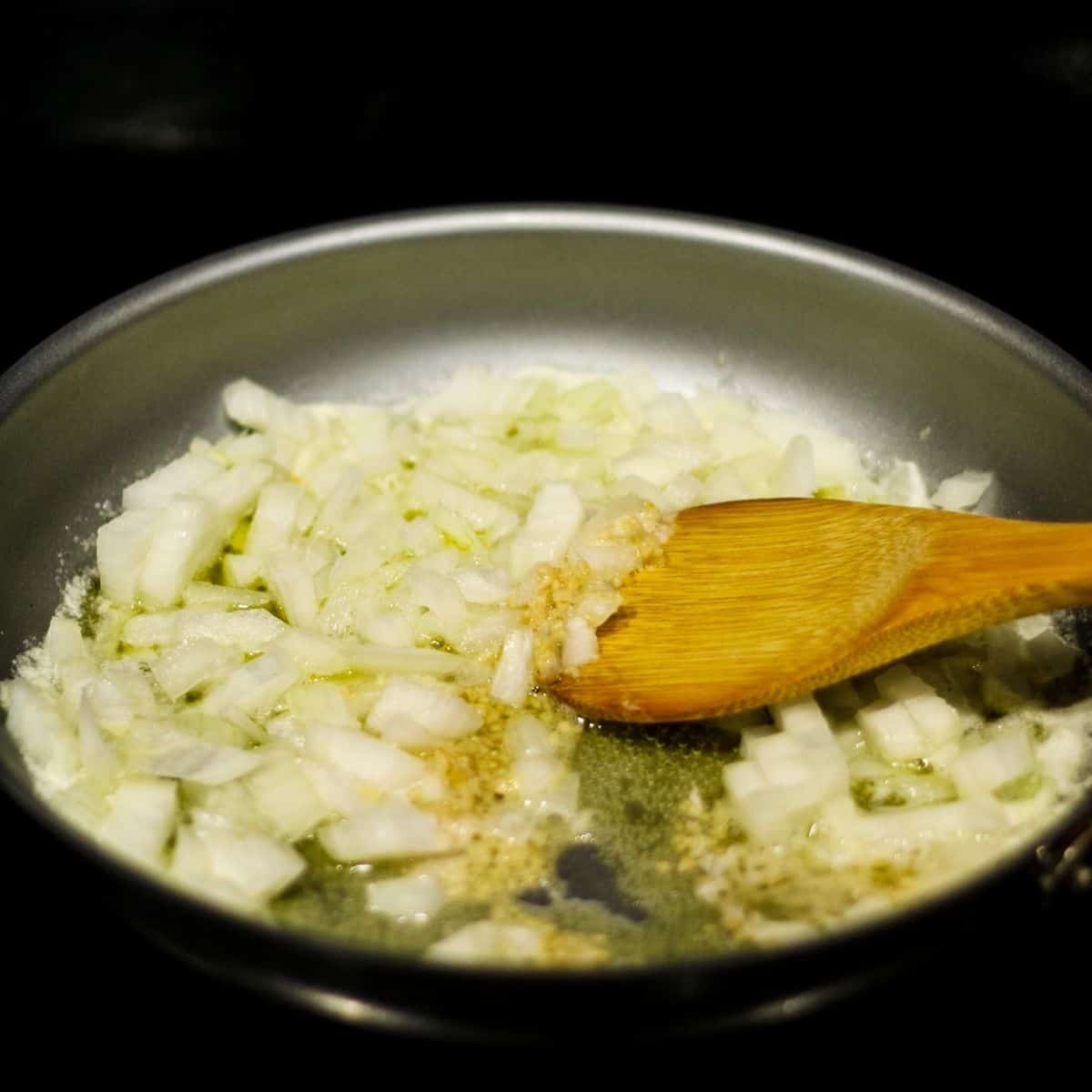 Cooking onion and garlic in melted butter.