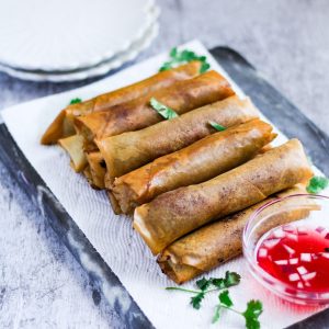 Finish dish of beef lumpia with a dipping sauce.