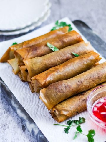 Finish dish of beef lumpia with a dipping sauce.