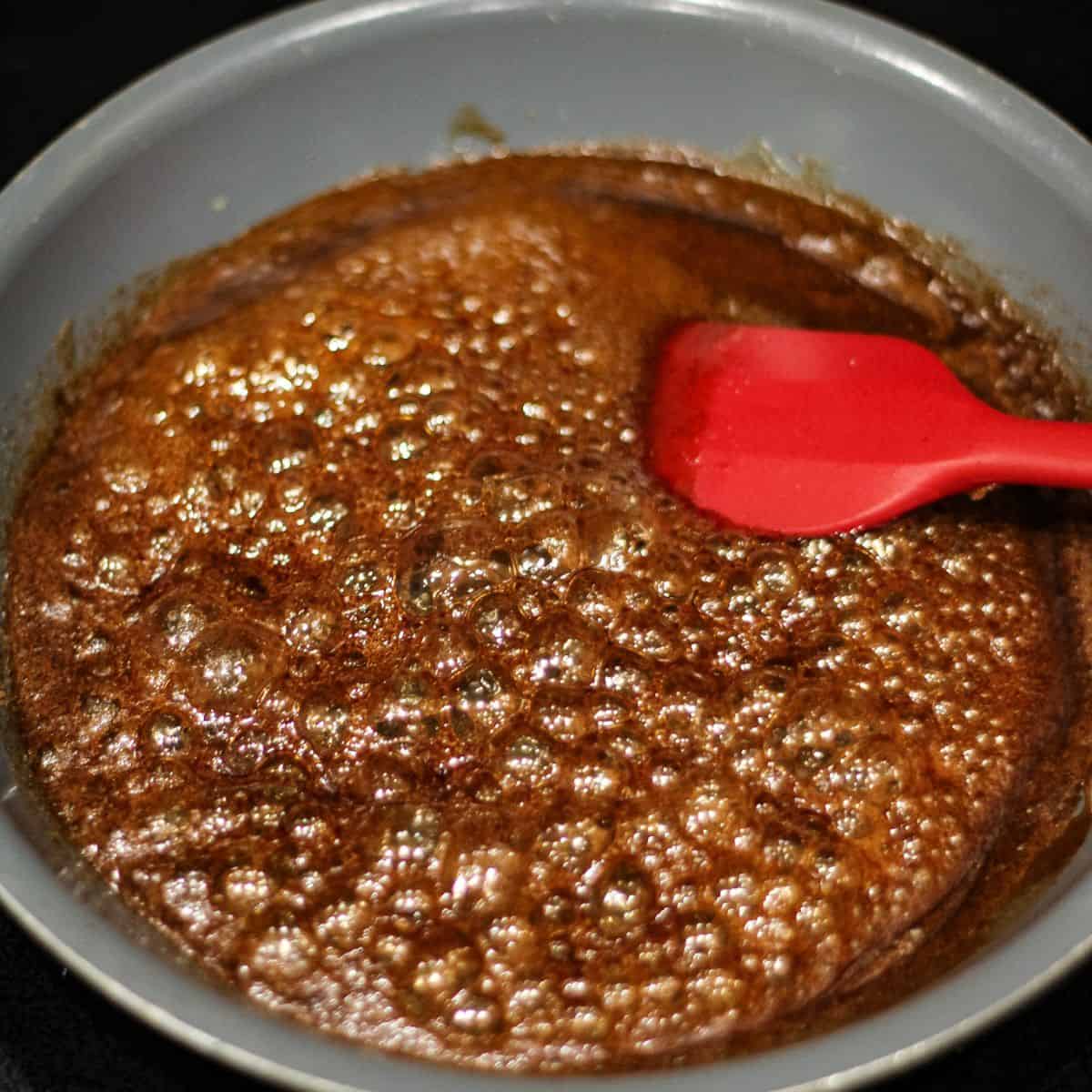 Caramel syrup in small pan.