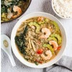 Finish dish of ginisang munggo with ampalaya and rice on the side.