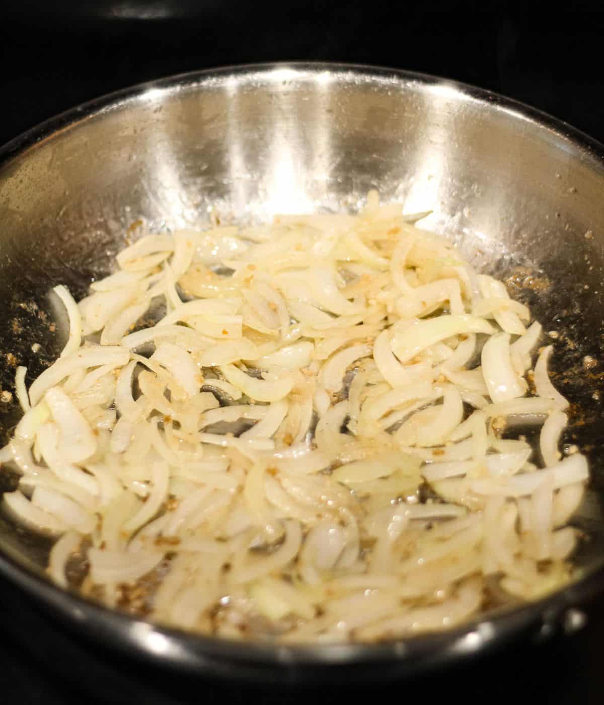 Cooking onion and garlic in a pan.