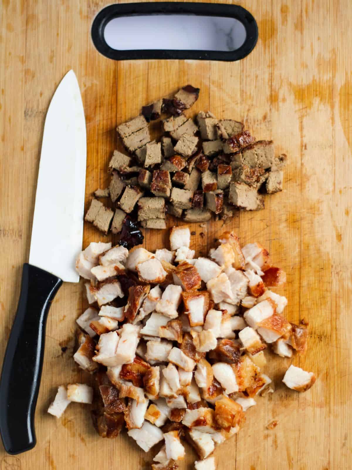 Chopped pork belly and pork liver in a chopping board.