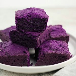 Slices of ube brownies on a plate.