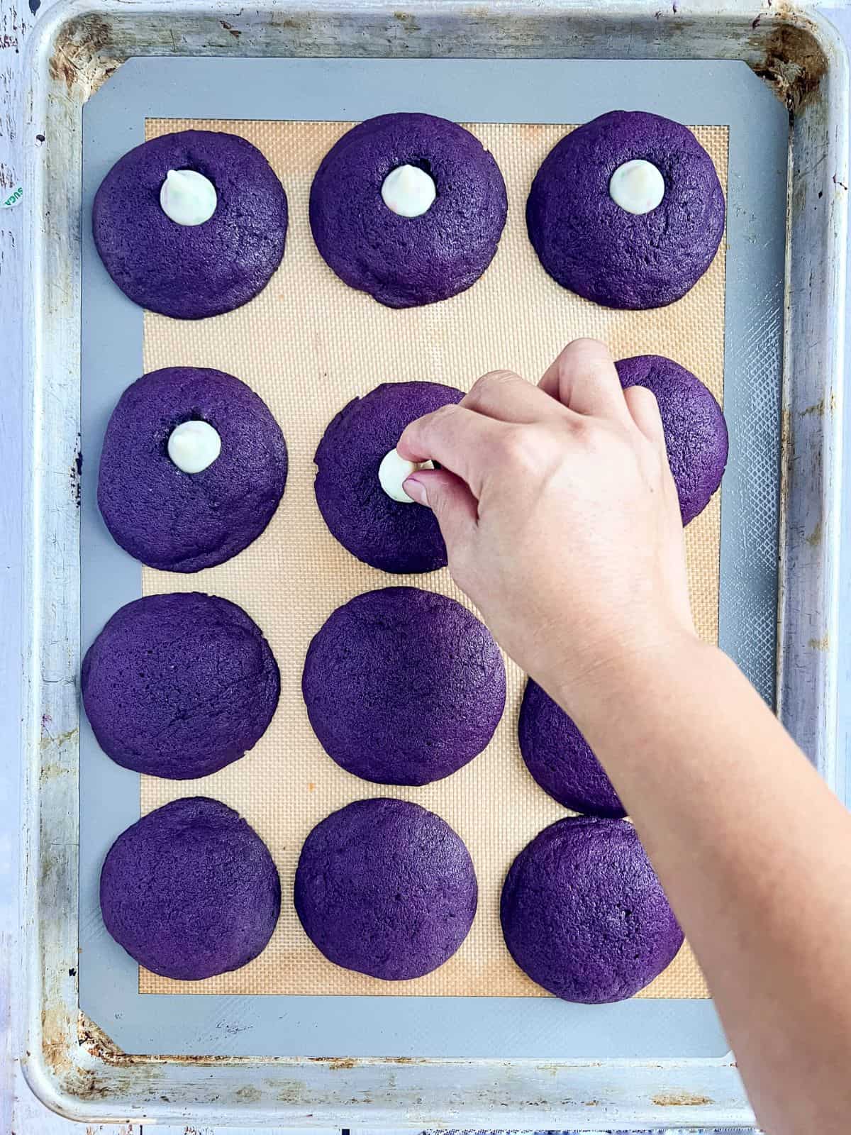 Baked ube cookies topped with milk chocolate.
