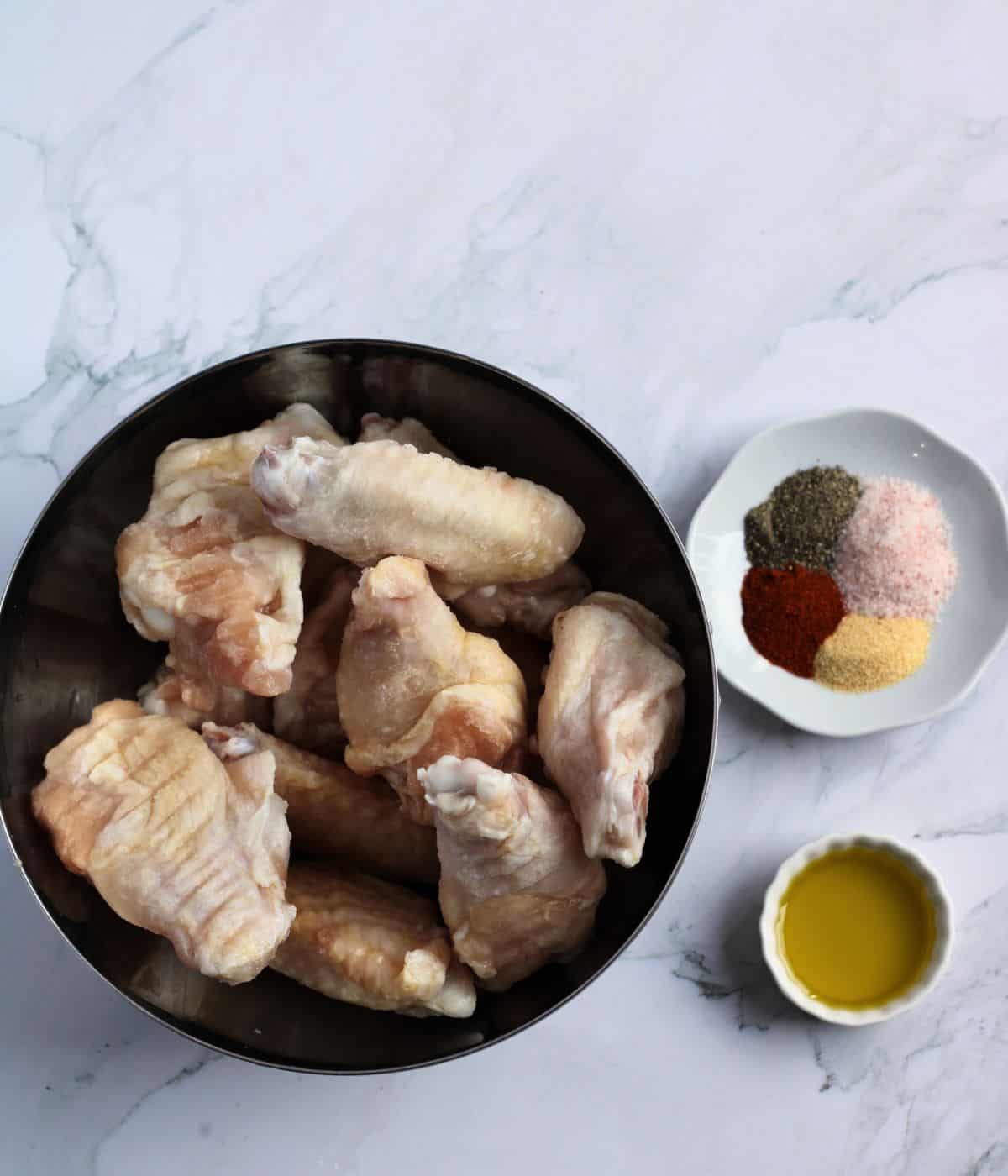 Ingredients and seasonings for air-fryer honey garlic chicken wings.