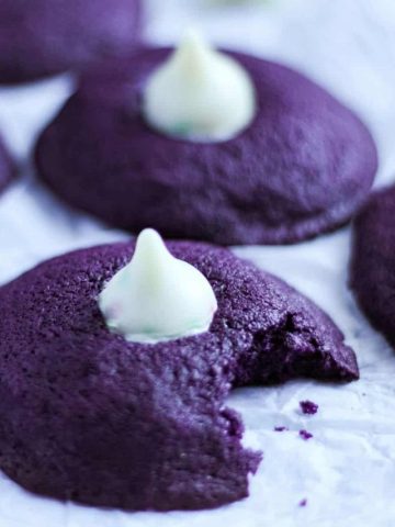 Ube cookies top with kisses chocolate on a table.