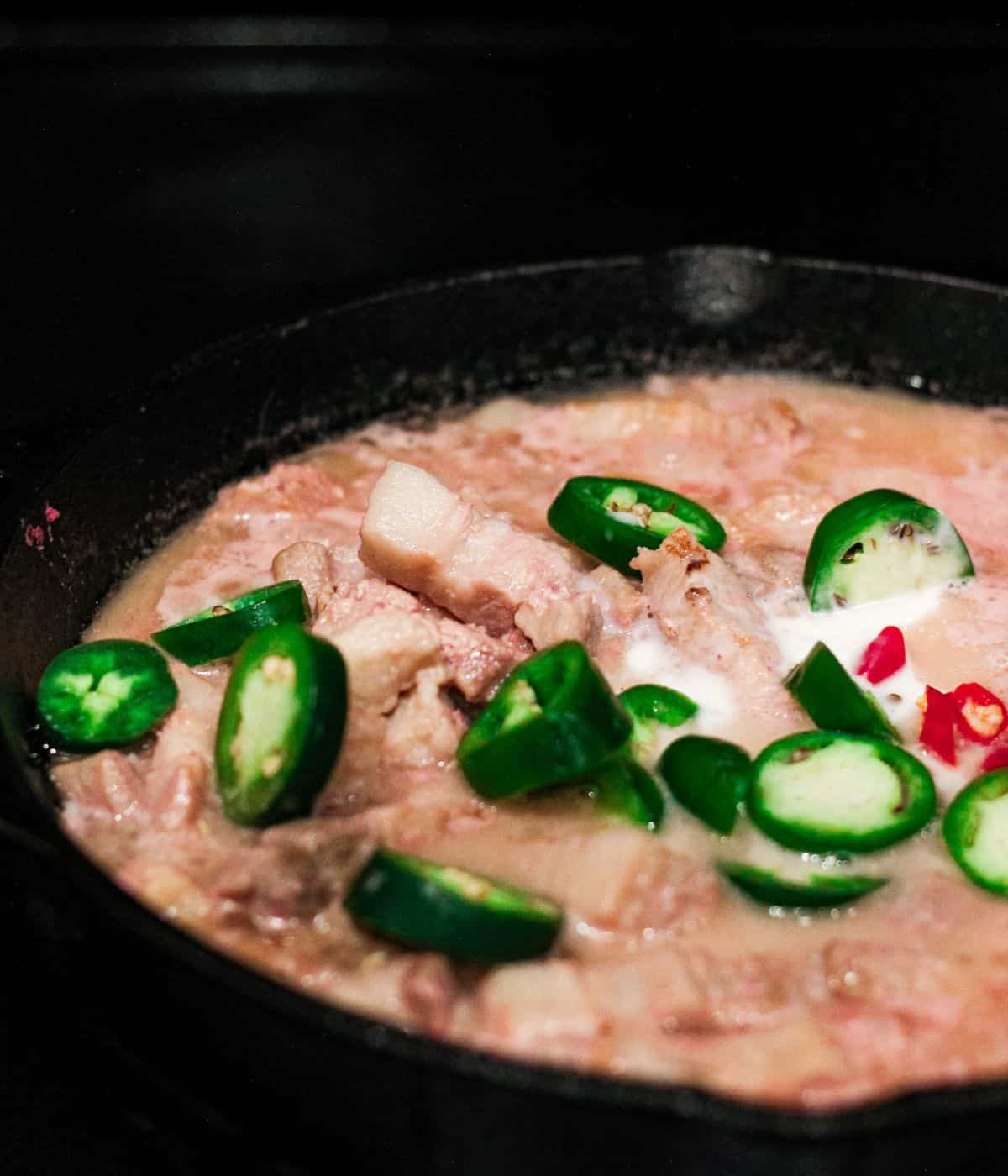 Adding green and red chillies.