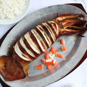 Finish dish of stuffed-grilled squid in a dishing plate.
