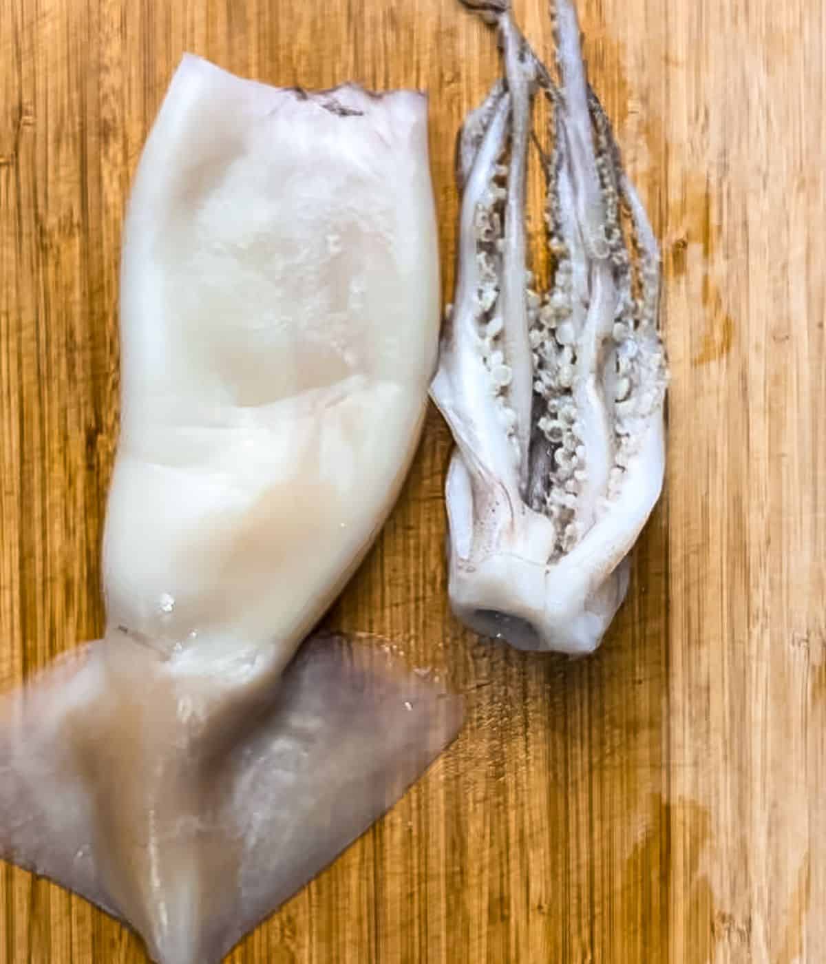 Cleaned squid on a chopping board.