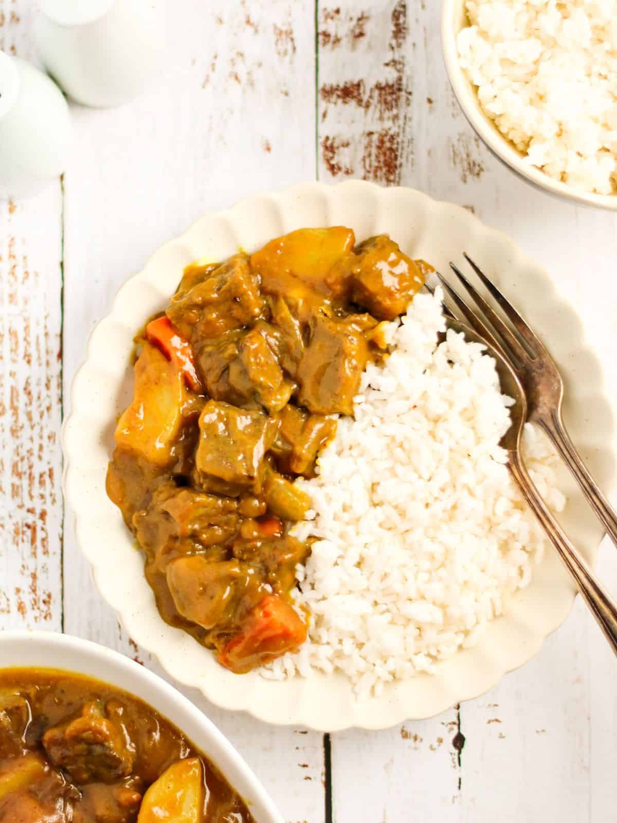 Japanese curry with white rice in a plate.