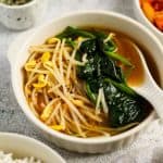 Finish dish of Korean spinach and soybean sprout soup in a bowl.
