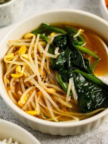 Finish dish of Korean spinach and soybean sprout soup in a bowl.